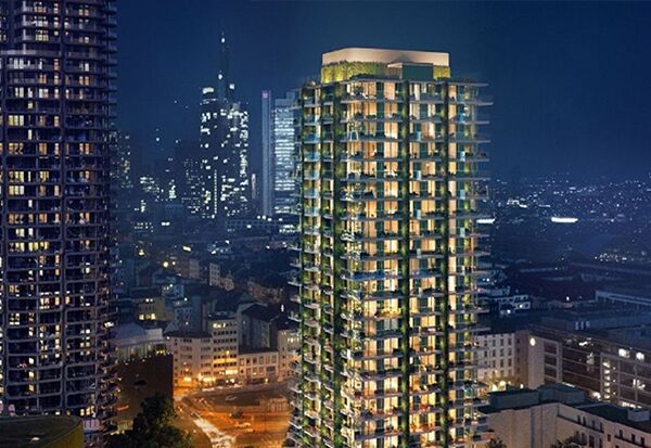 NOVIA: Projekt Eden Tower in Frankfurt am Main (Außenansicht des beleuchteten Gebäudes bei Nacht vor Frankfurter Skyline)